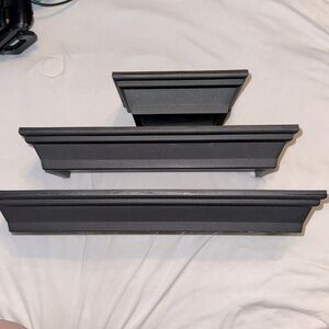 Black plastic wall shelves